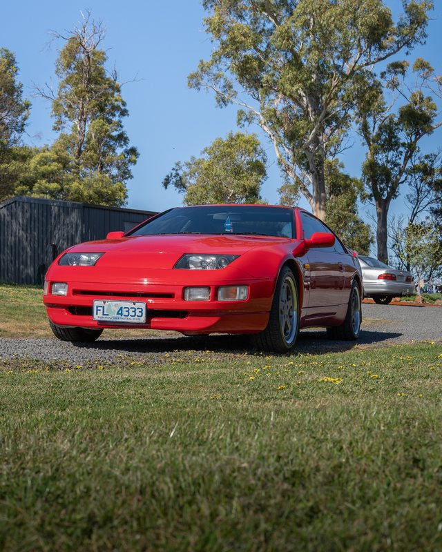 Red 1990 Nissan 300ZX, low front three-quarter view under gum trees in Tasmania